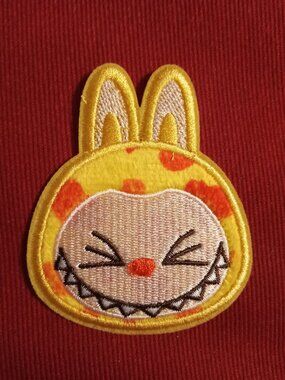 Yellow and orange squinting labubu stick on embroidered patch applique